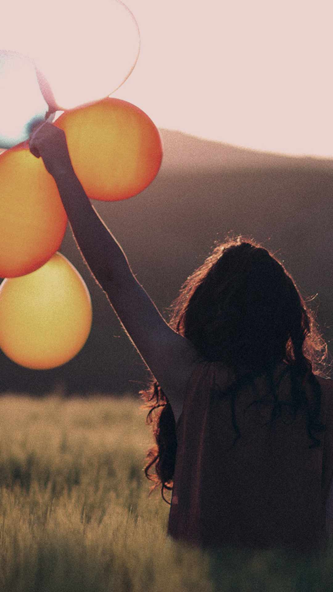Junge Frau hält bunte Luftballons in die Sonne - Folge MAXENERGY auch in den sozialen Netzwerken und erfahre interessante Facts zu Strom und Gas. Mobile Ansicht.