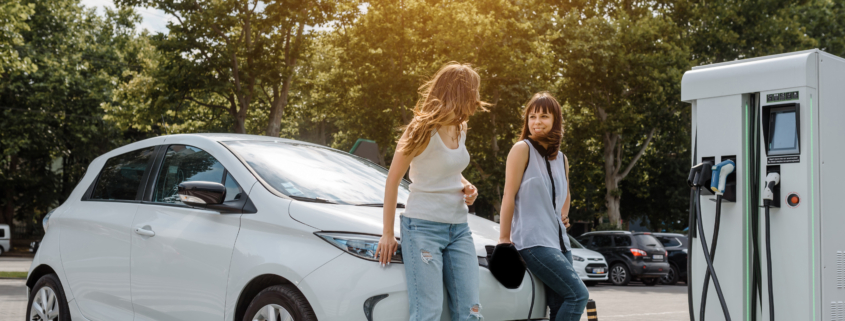 Two happy young beautiful women are talking to each other until