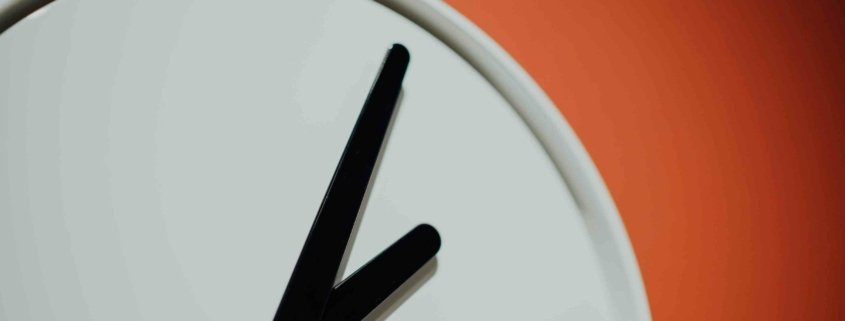Eine Uhr vor orangem Hintergrund - ab Juni können Stromkunden in Deutschland in 24 Stunden ihren Anbieter wechseln.